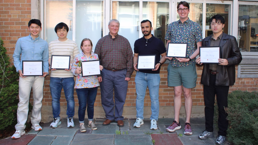 Graduate student mentoring award winners (from left) Hangyu Li, Shengdong Liu, Inna Popova Saleh Alshammari, Eric Kastelic and Zilin Huang stand with Department of Civil and Environmental Engineering Chair Greg Harrington (center) at an awards reception