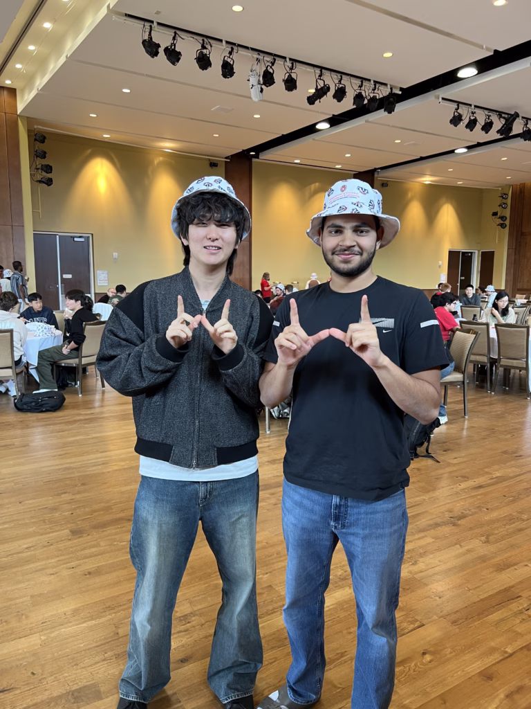 Two students making W symbol with hands