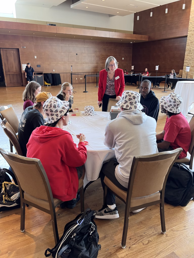 Department chair talking with students at round table