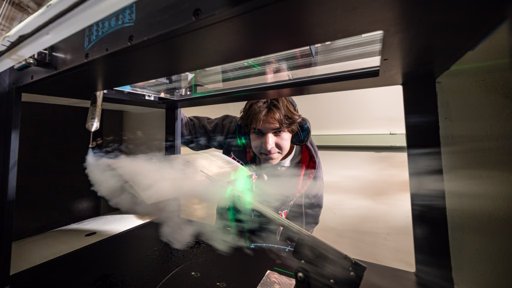 Undergraduate student Sam Snyder works with the college's new educational wind tunnel