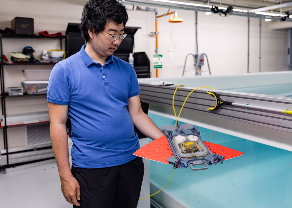 Master's student Sicheng Fu shows off a robotic manta ray