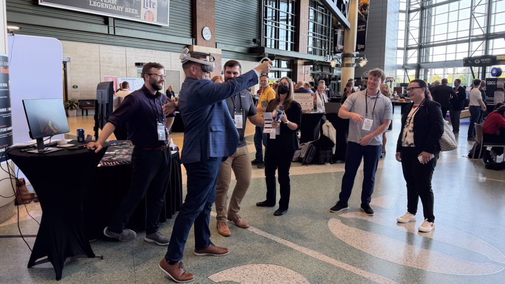 Attendees try out a VR headset at the Wisconsin Drives Manufacturing Summit on June 1, 2026 at Lambeau Field