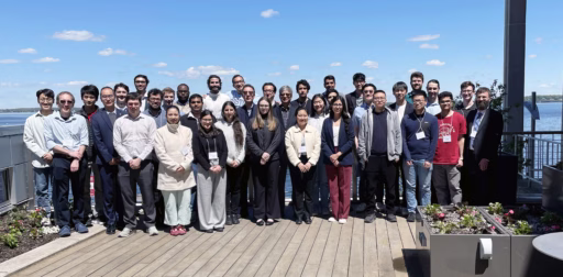 A group photo of the 2026 Hougen Symposium in front of Lake Mendota.