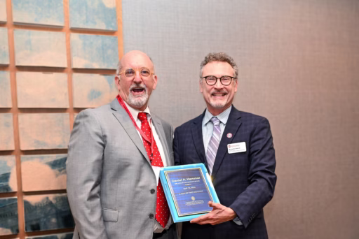 BSL lecture Daniel Hammer stand with professor Mike Graham while given an award.