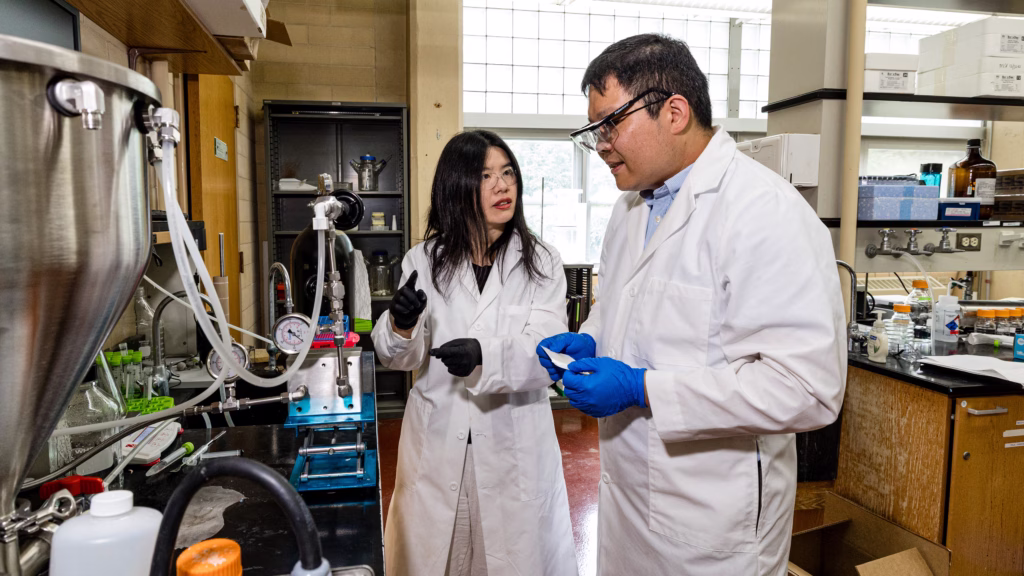Assistant Professor Mohan Qin, left, discusses ammonia filtration with Professor Ying Li