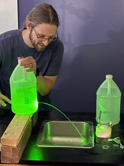 Franklin Hobbs conducts science experiment in the classroom.