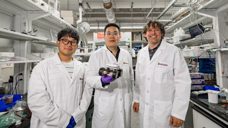 PhD student Euigeol Jung, former postdoctoral fellow Yichao Shi and Professor James Pikul hold a robotic rover that’s powered by their aluminum-air battery