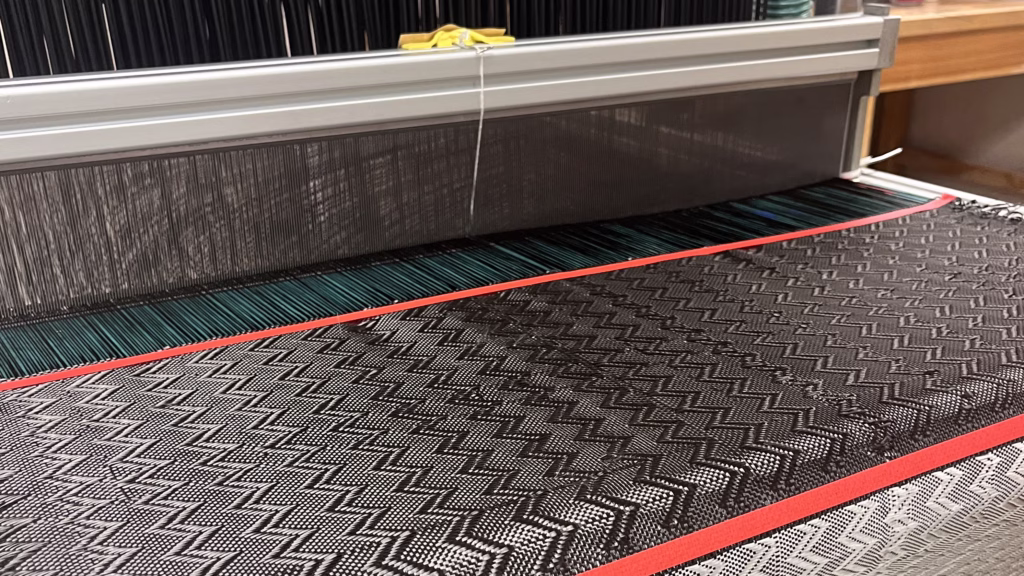 Associate Professor Pavana Prabhakar’s lab group used a loom to weave a metal “yarn” into a carbon fiber fabric