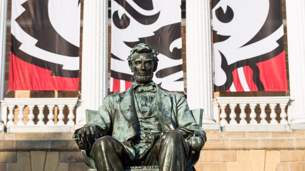 The Abraham Lincoln statue is pictured with a graphic of mascot Bucky Badger's face hangs between the columns of Bascom Hall at the University of Wisconsin-Madison during autumn on Oct. 27, 2014. (Photo by Jeff Miller/UW-Madison)