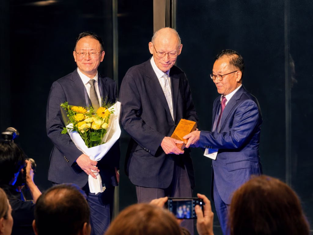John Perepezko receives an award on stage