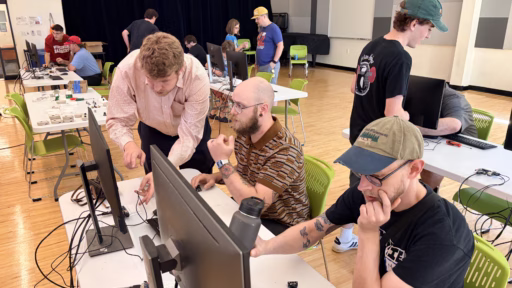 Assistant Professor Michael Biehler assists participants at the 2026 Adaptive Gaming Expo in Madison